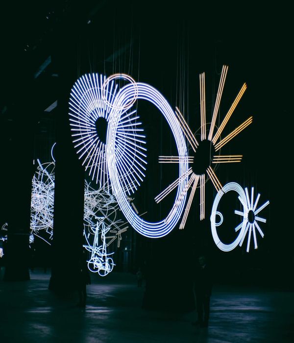 Abstract glowing geometric shapes in dark indigo environment